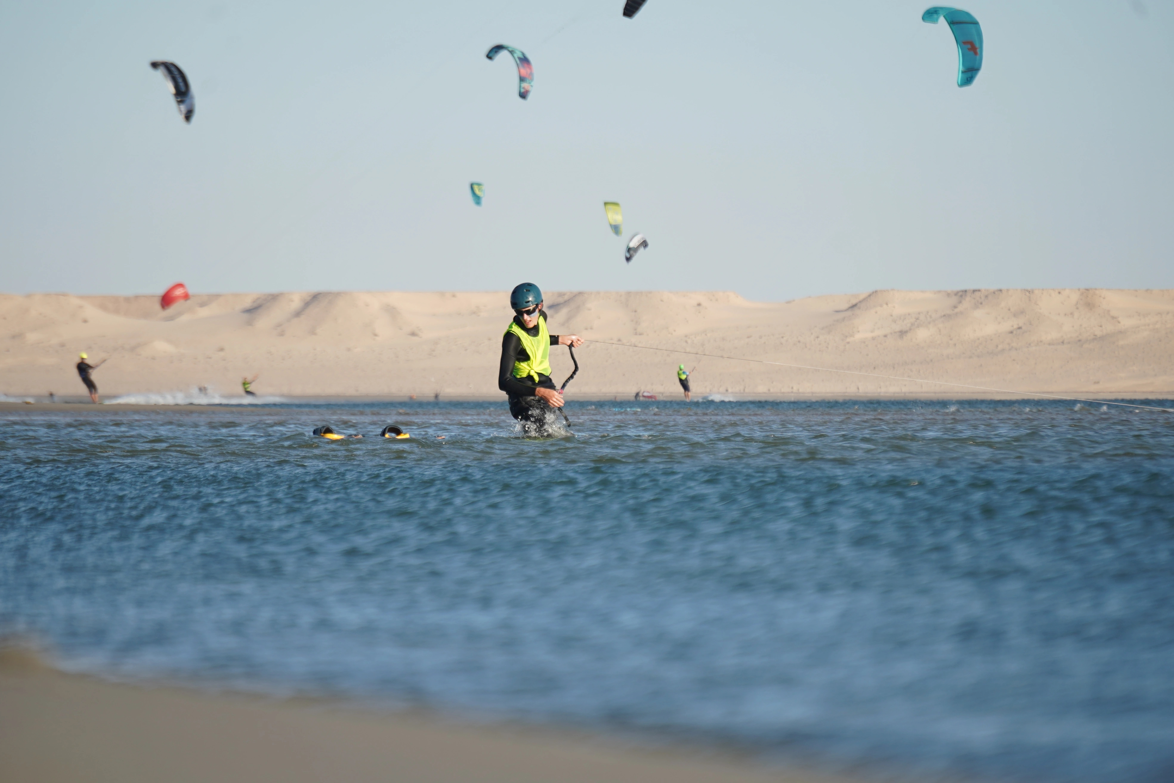 A kitesurfer training at high speed on the perfectly flat water of the Dakhla Speed Spot during a Bluboarding excursion.