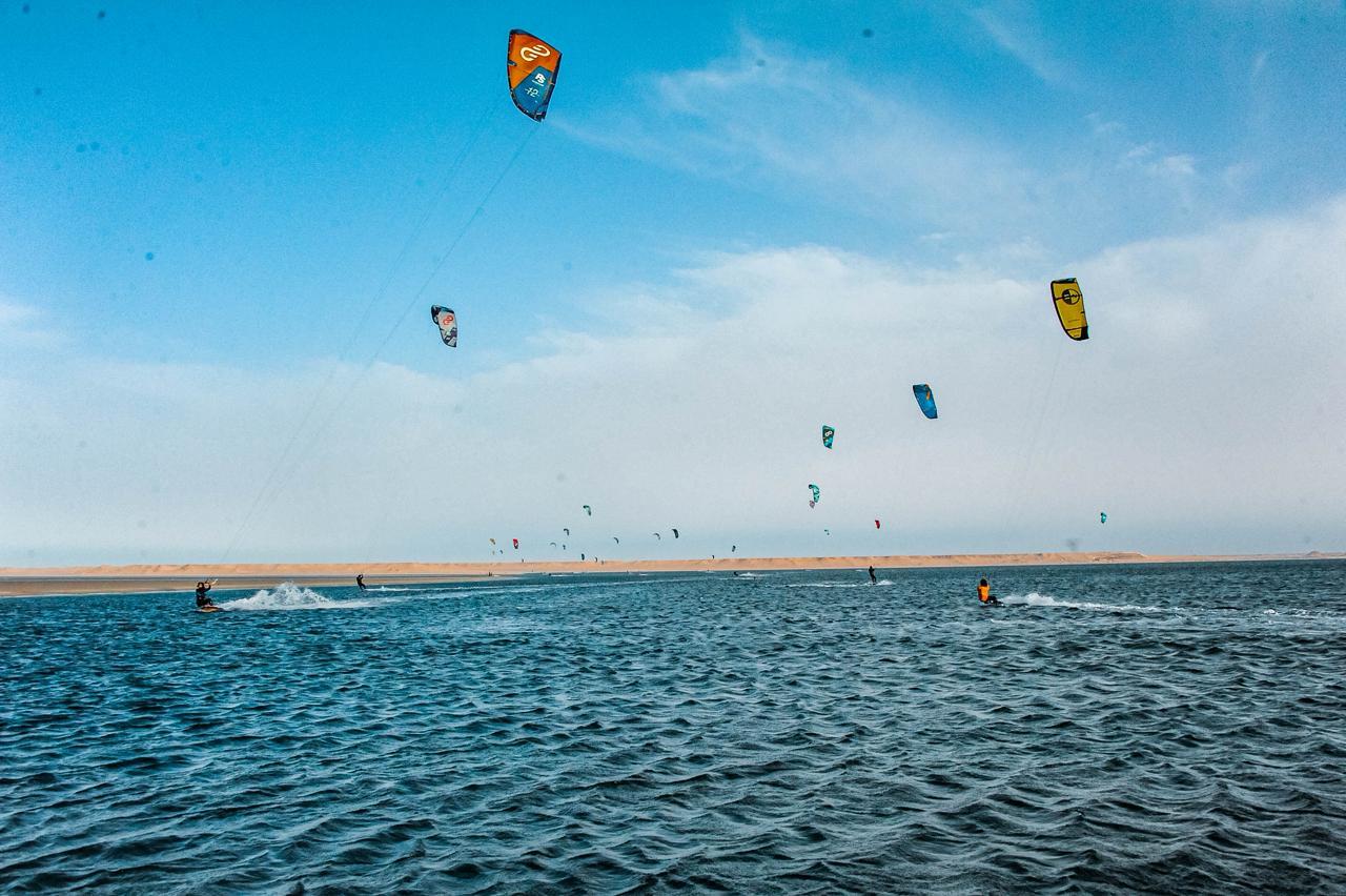 Bluboarding clients riding at Speed Spot on the flat water of the Dakhla lagoon during a guided speed session.