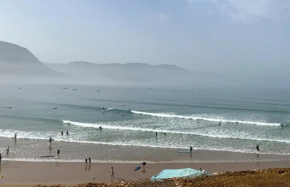 Bluboarding clients surfing at Imsouane with consistent wave series rolling in during a guided day trip from Essaouira.