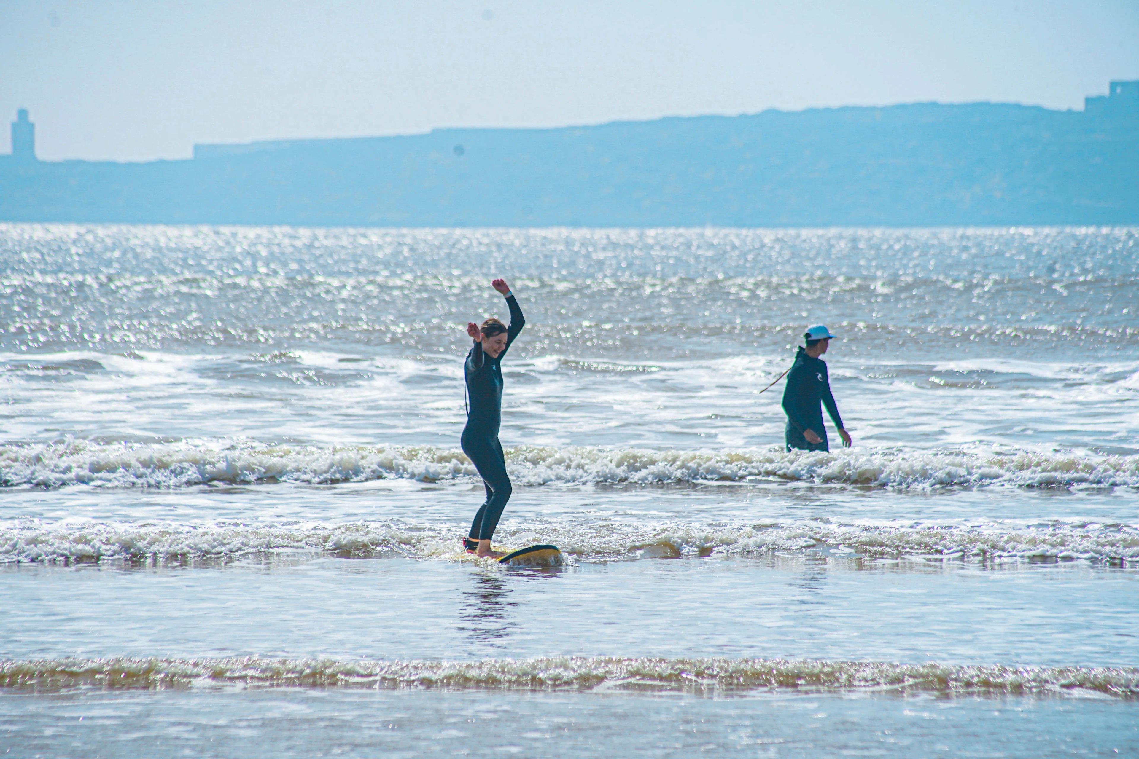 A surfer catching a clean, uncrowded wave during a Bluboarding surf lesson in Dakhla.