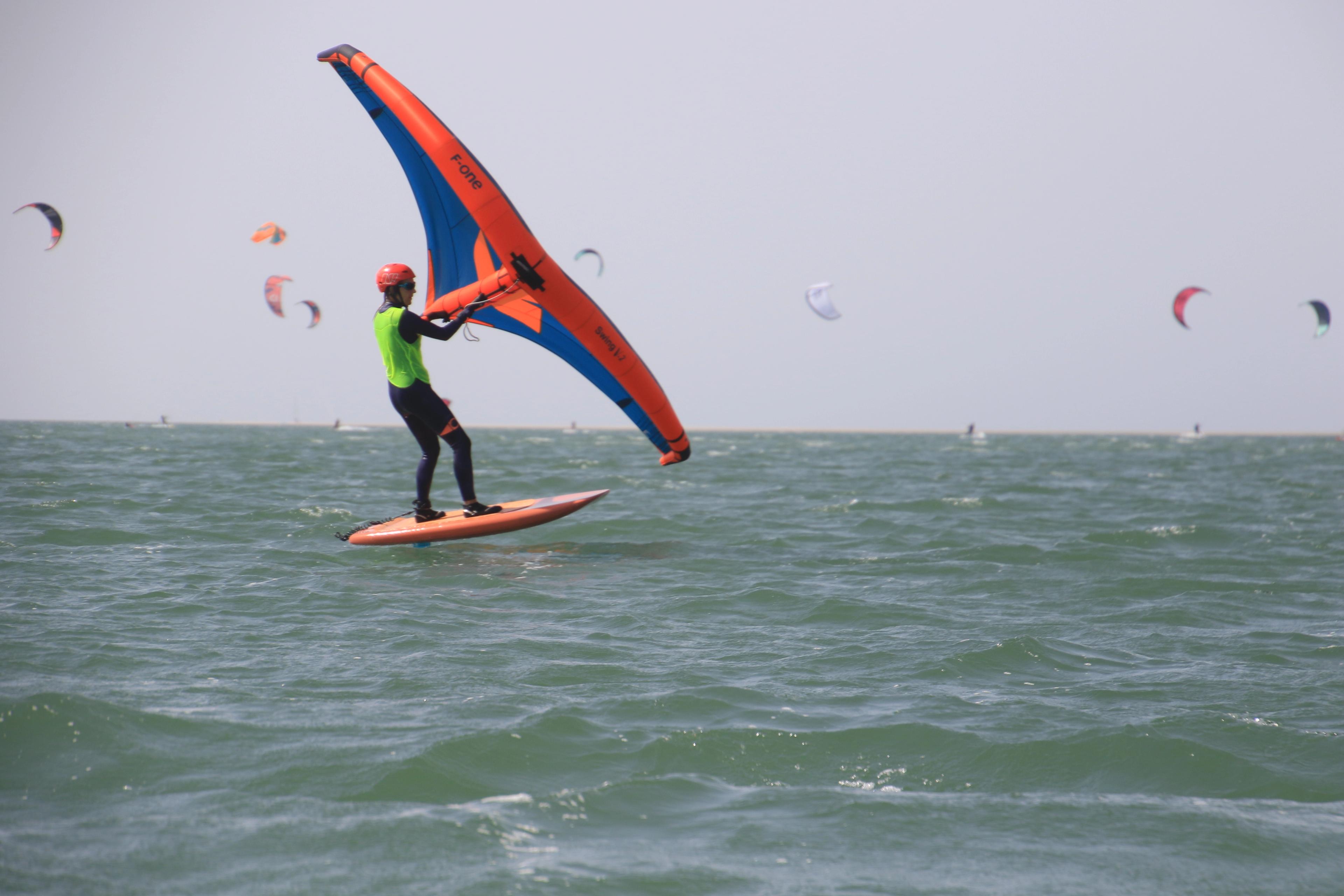 Wingfoil beginner learning in flat water inside the Dakhla lagoon, practicing balance and control in calm conditions