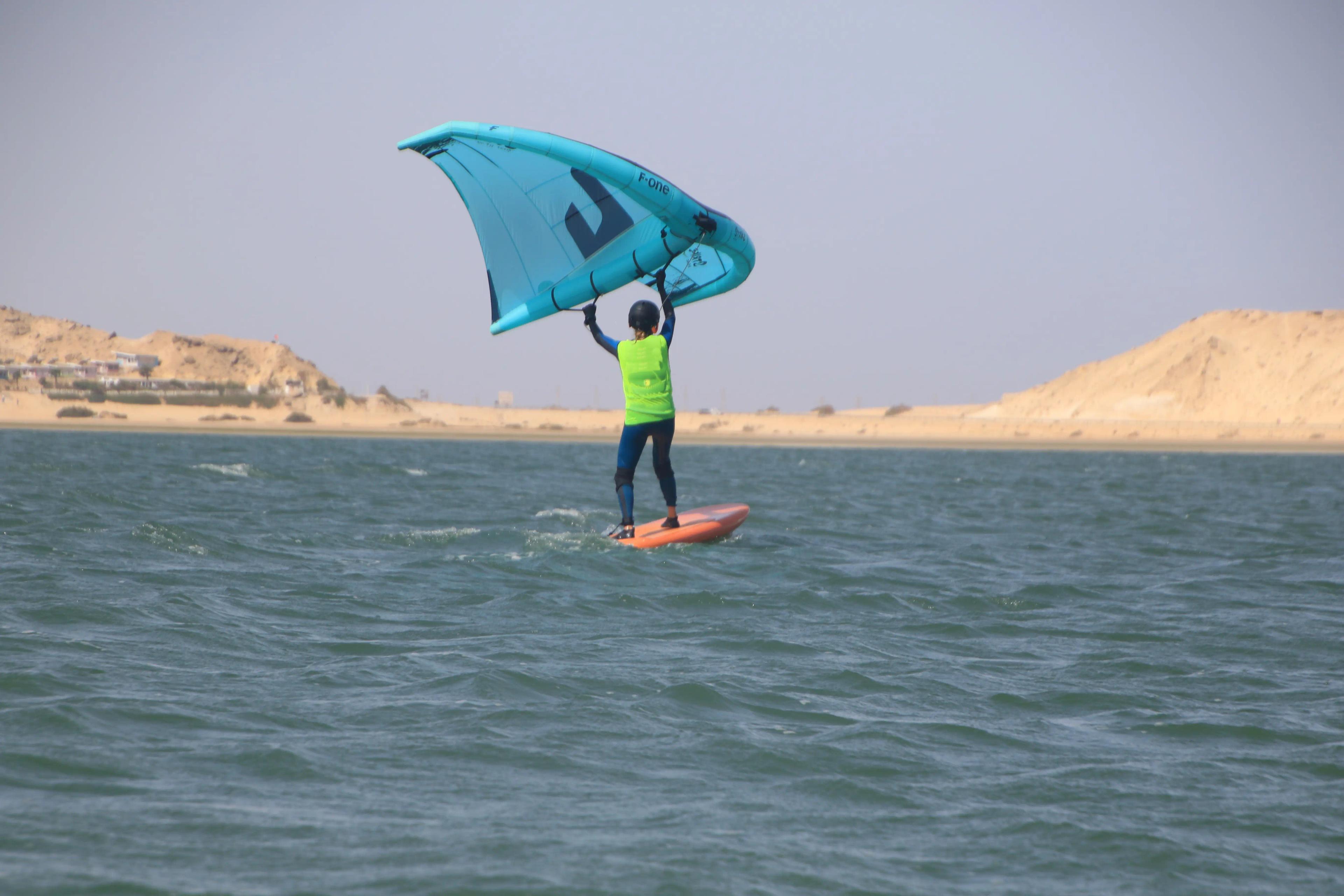 wingfoil-beginner-on-the-board-taking-off